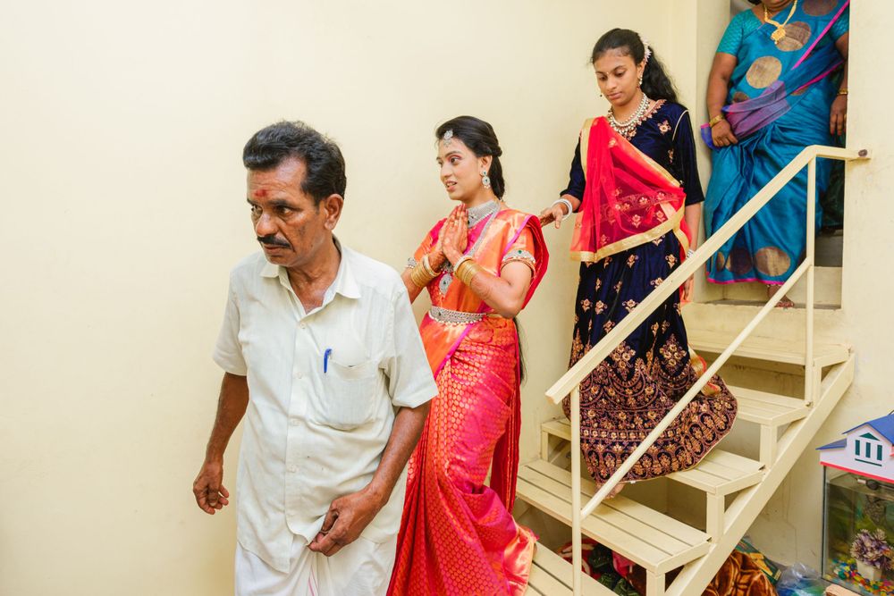 People in traditional Indian attire descend stairs during a ceremonial event.