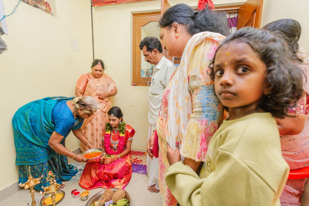 Traditional ceremony participants gather around for a ritual on the floor.
