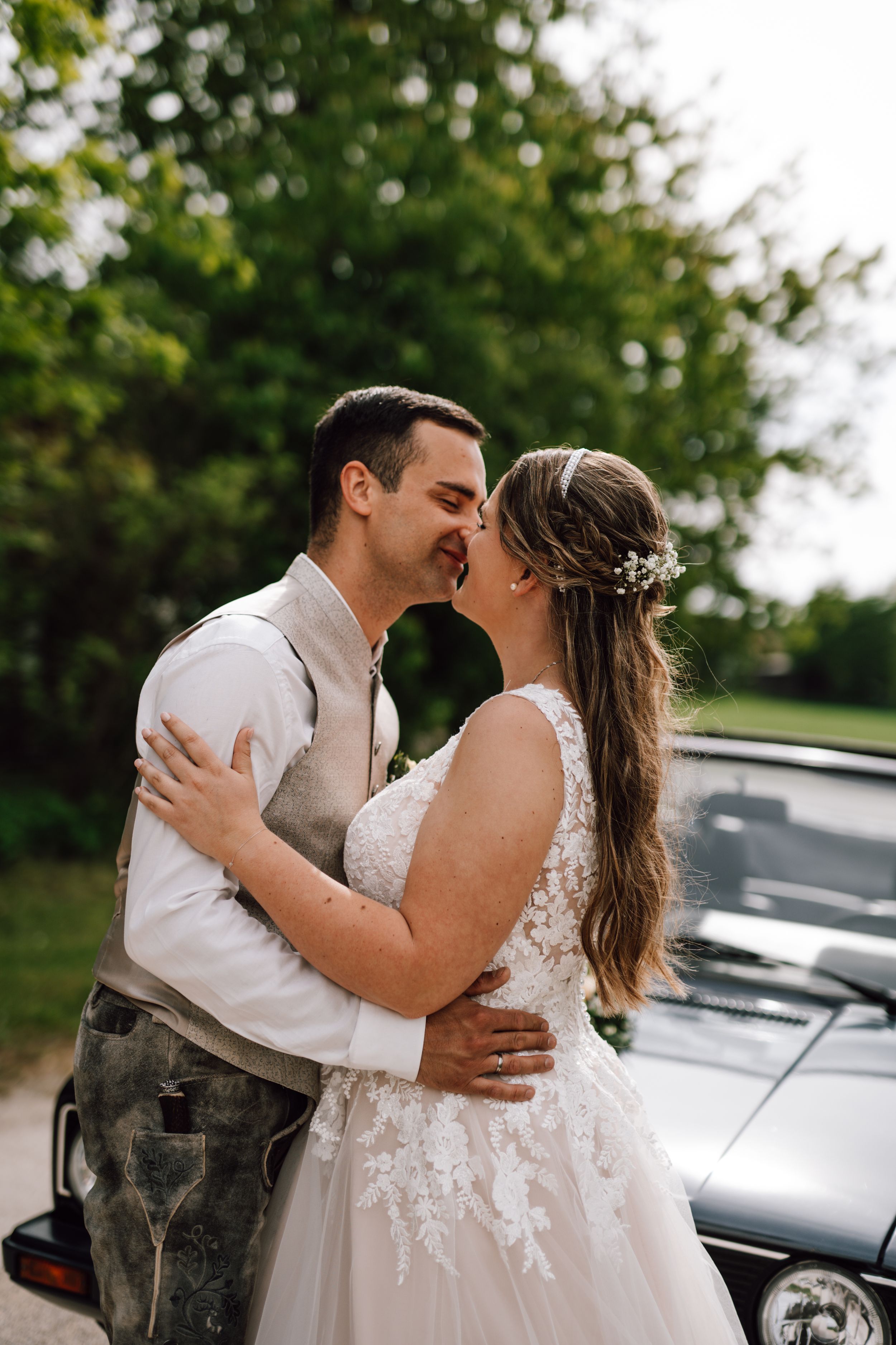 Sweet candid moments between newlyweds during their outdoor wedding photo session.