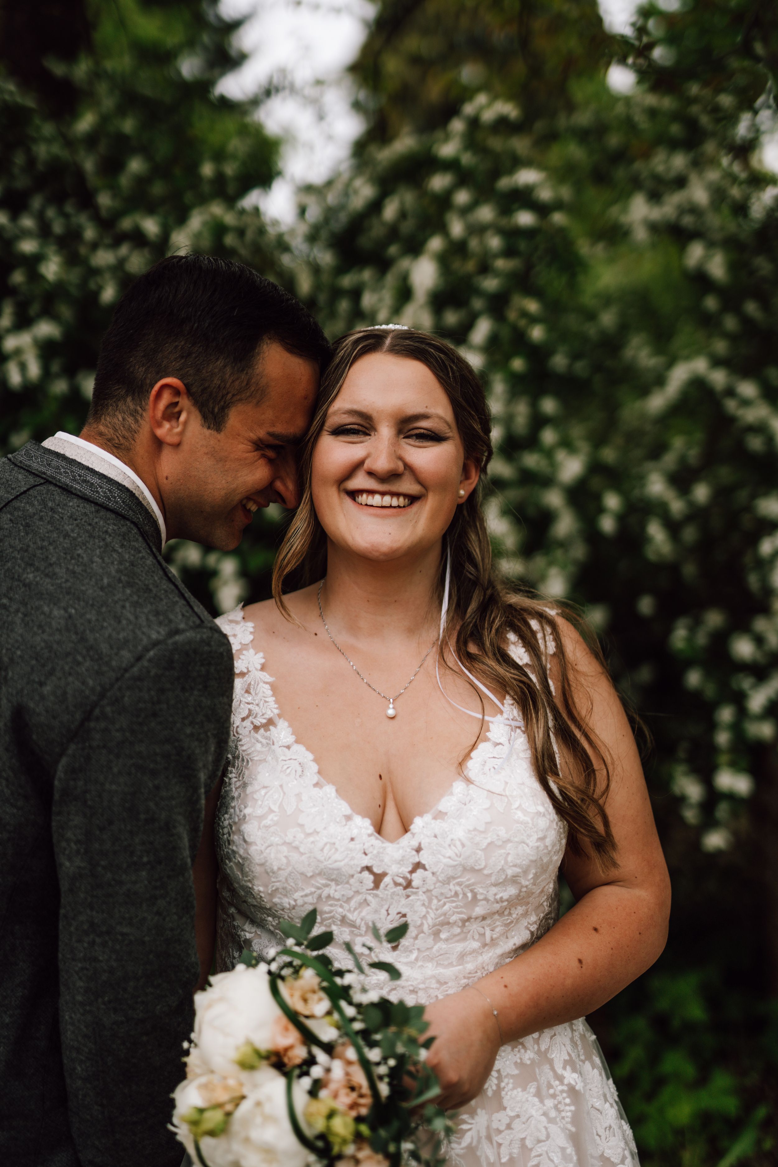 Candid wedding photography showing joyful moments in a garden setting.