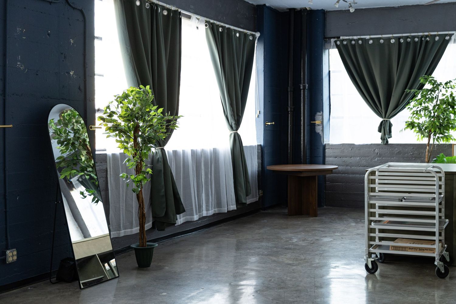 Los Angeles boudoir photo studio with large windows draped with long curtains.
