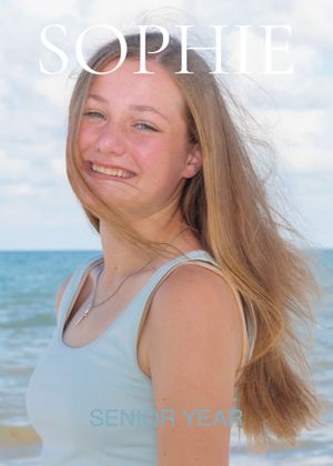 Smiling teenage girl with long blonde hair at the beach for her senior year photo.