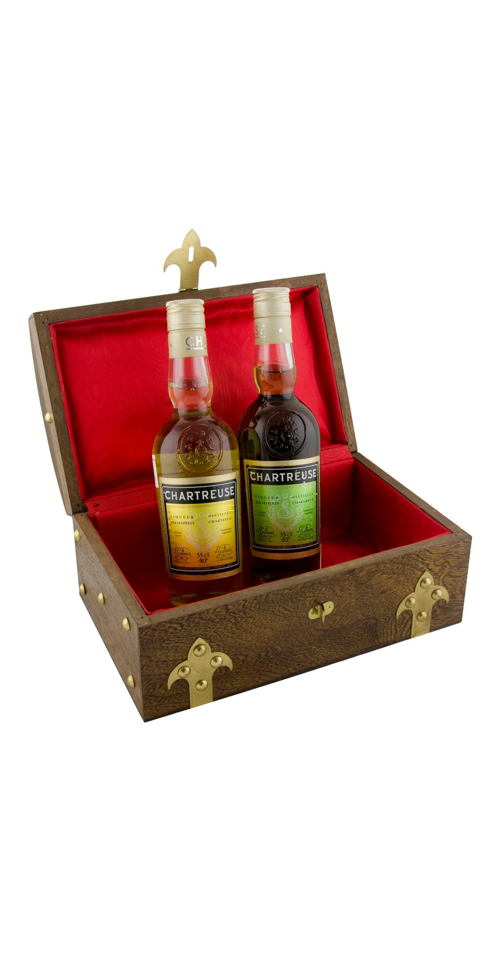 Two bottles of Chartreuse liqueur displayed in an ornate wooden box with red velvet lining and fleur-de-lis decorations.
