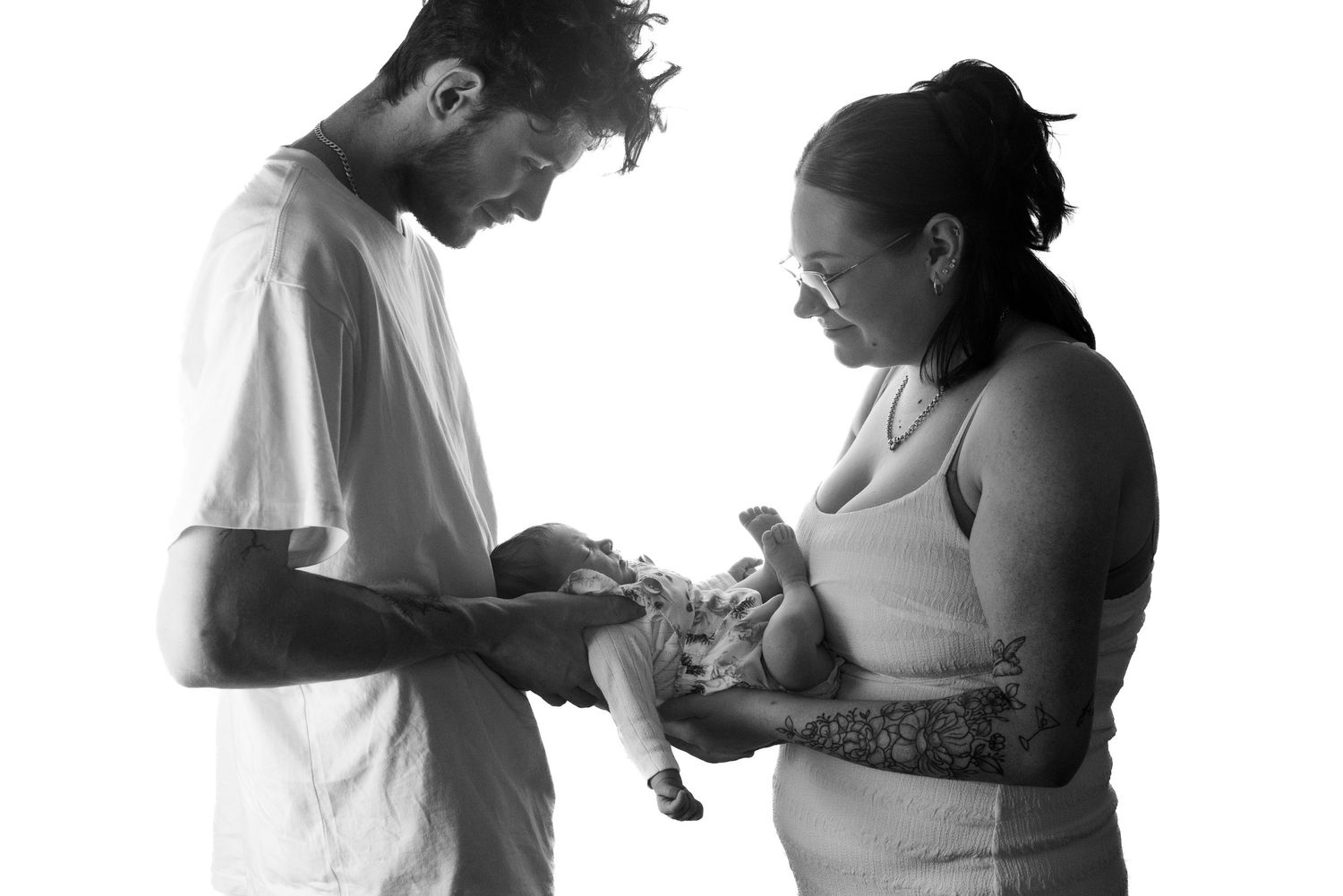 A black and white portrait showing a tender family moment.