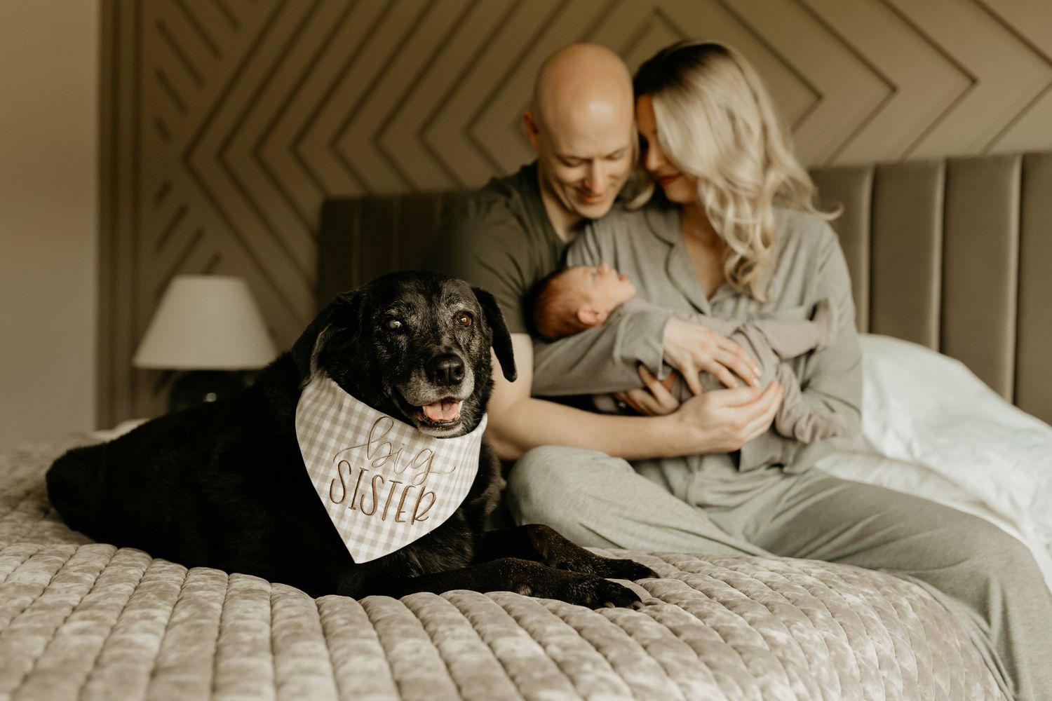 An affectionate couple shares intimate moments while relaxing together on crisp white bedding.
