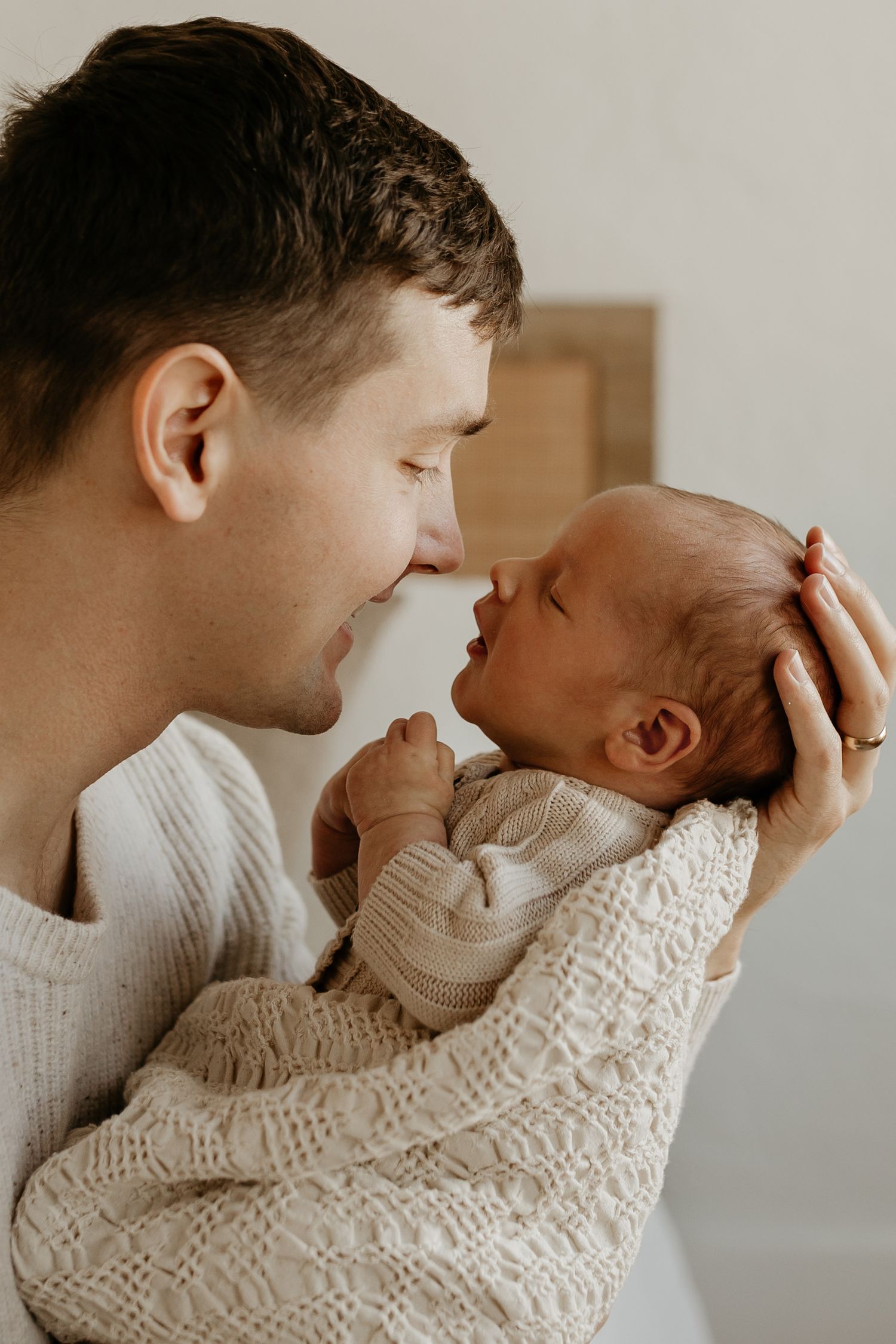 A tender moment captured in a series of candid interactions between parent and child in soft, warm lighting.