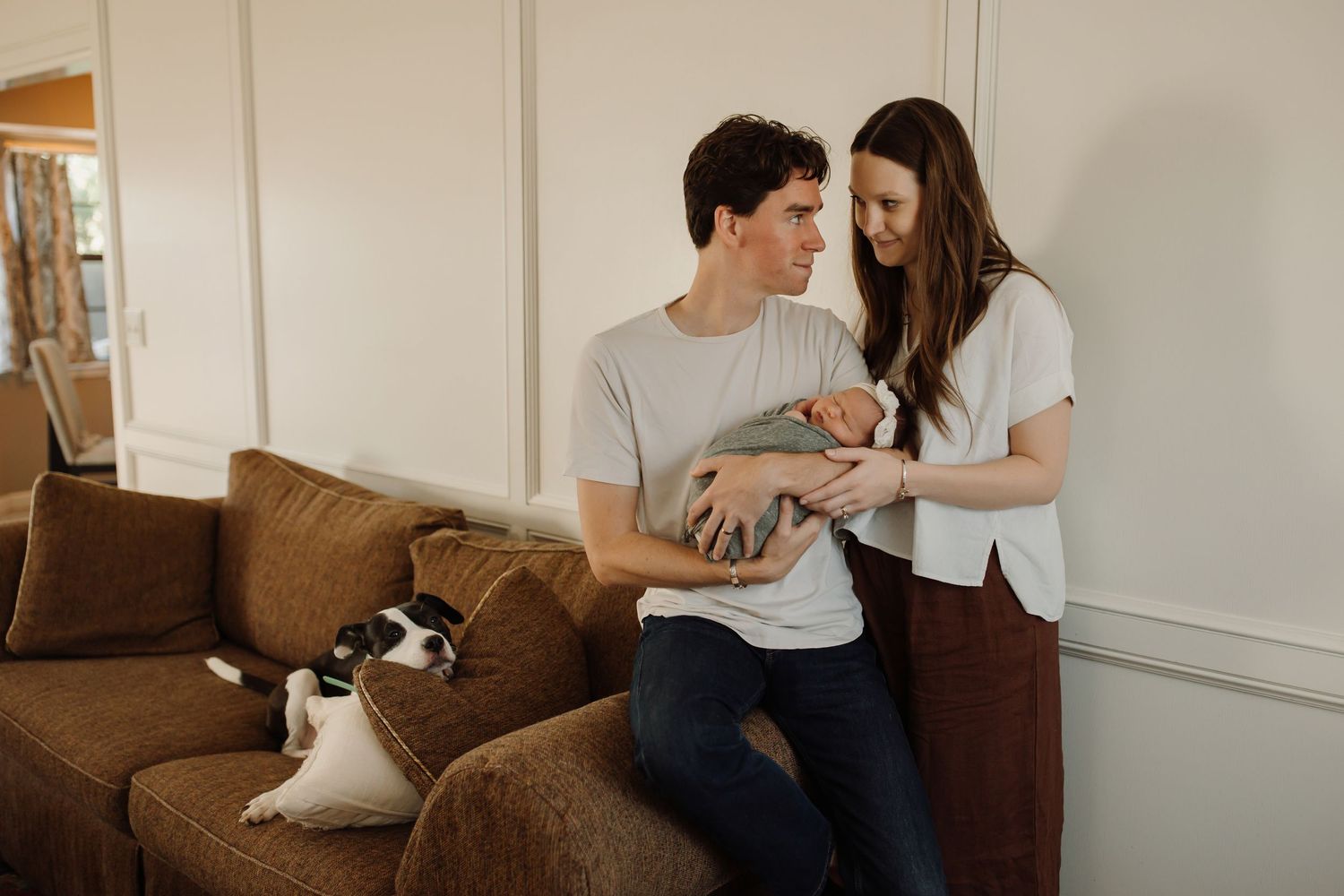 A couple sits on a brown couch in a living room, sharing intimate moments in a photo collage.