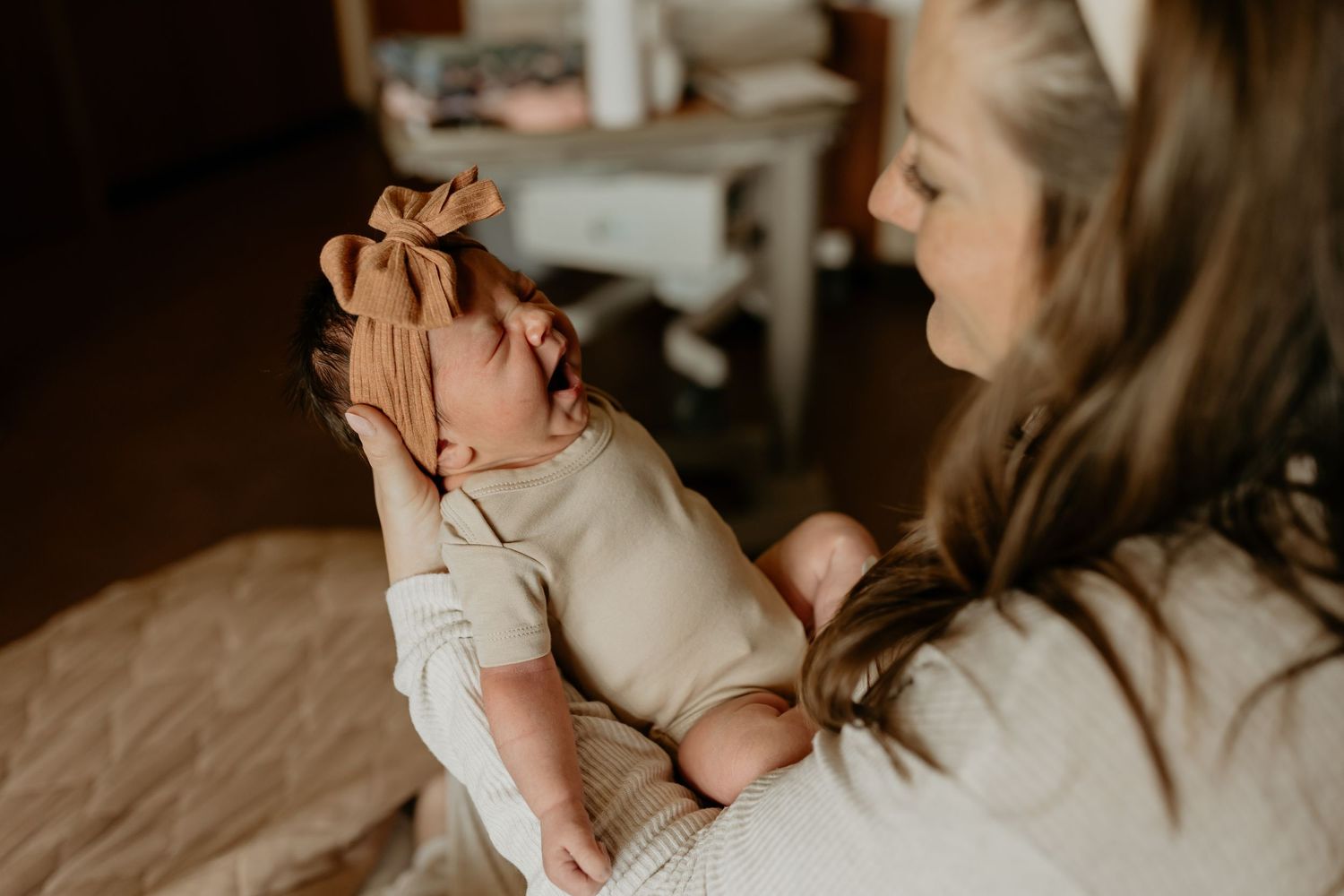 A series of intimate family moments showing a mother nursing and bonding with a newborn baby in soft natural light.