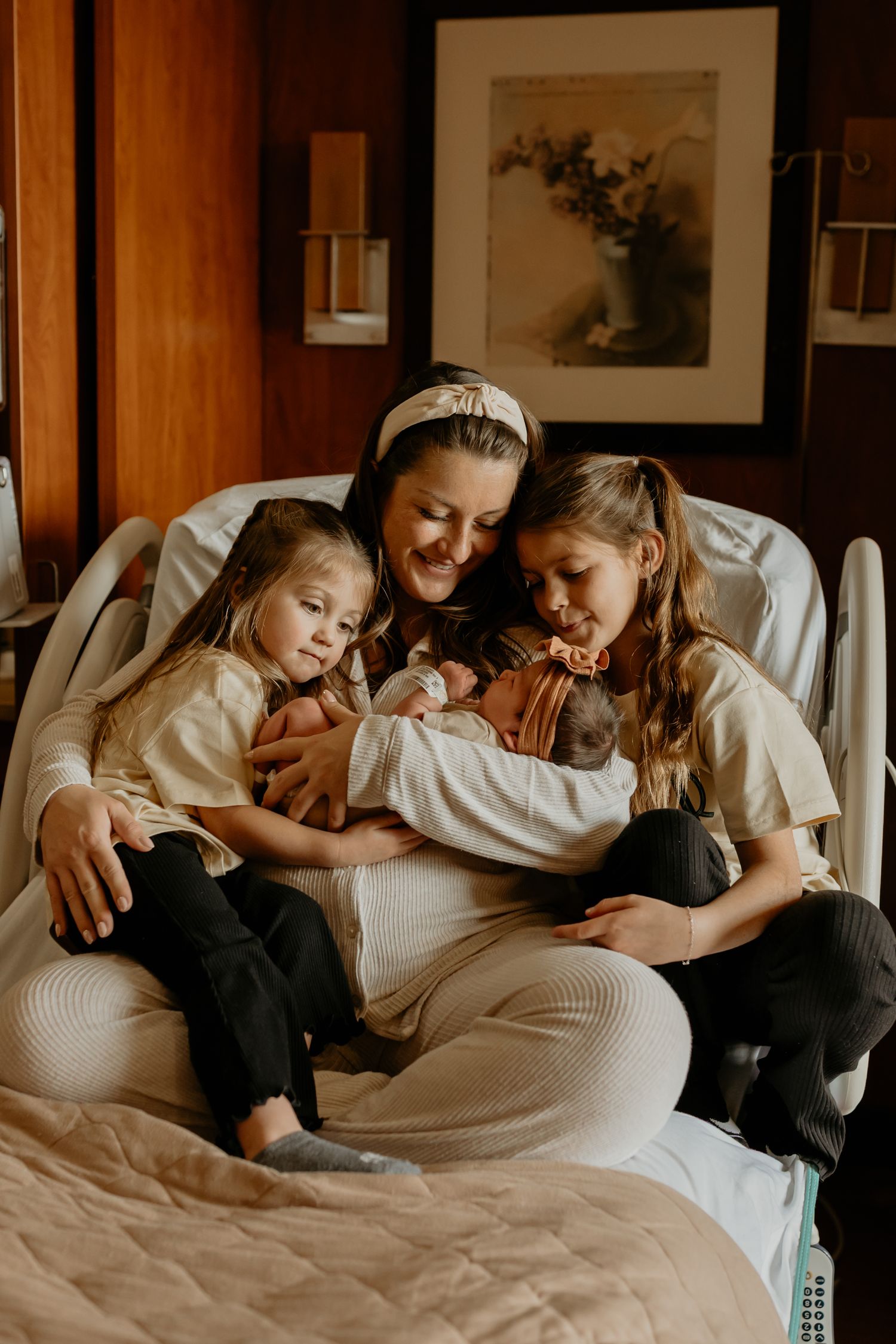 A series of intimate lifestyle photos showing a family cuddling together on a white bed in warm lighting.