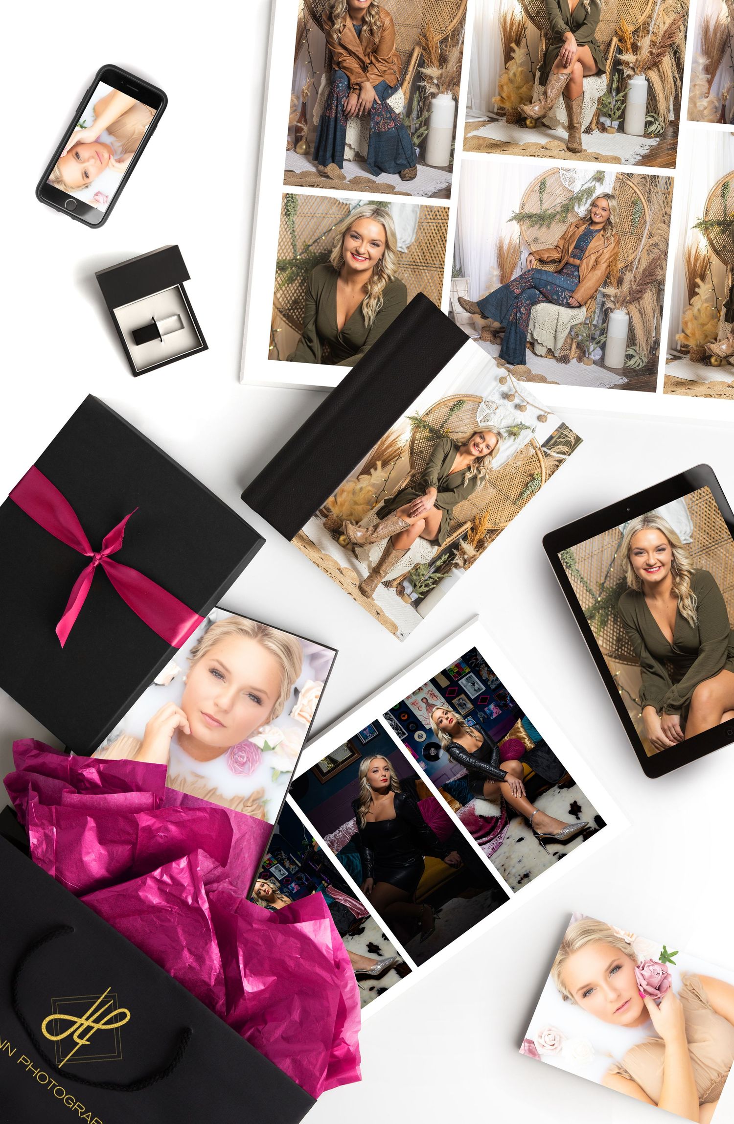 Flatlay of photography products including prints, box with pink bow and mobile devices.