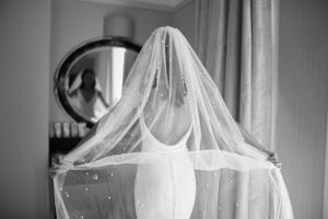 Classic black and white bridal portraits showcasing wedding dress and veil details.
