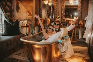 Warm-toned wedding reception photos with romantic lighting and dancing in an elegant venue.