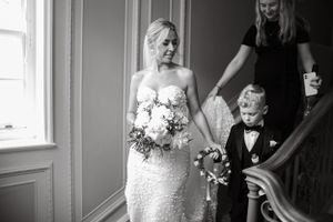 Black and white wedding preparation scene in elegant room with window light.