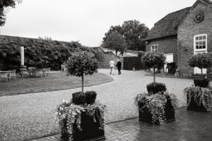 Scenic view of an English countryside wedding venue with stone buildings and gardens.