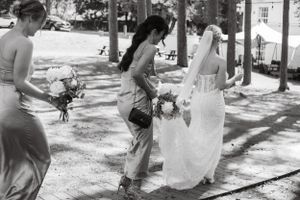 Black and white photo of wedding party walking together outdoors.