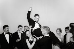 Wedding celebration with guests dancing and having fun in black and white.