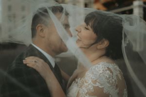 Intimate wedding moment captured in soft, romantic lighting.