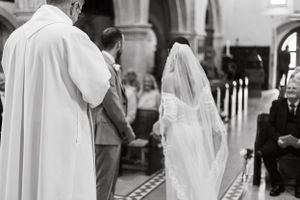 Wedding ceremony processional in a traditional church setting.