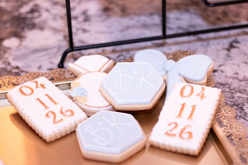 White ceramic hexagonal cookies with gold numbers arranged in a sequence on a textured surface.