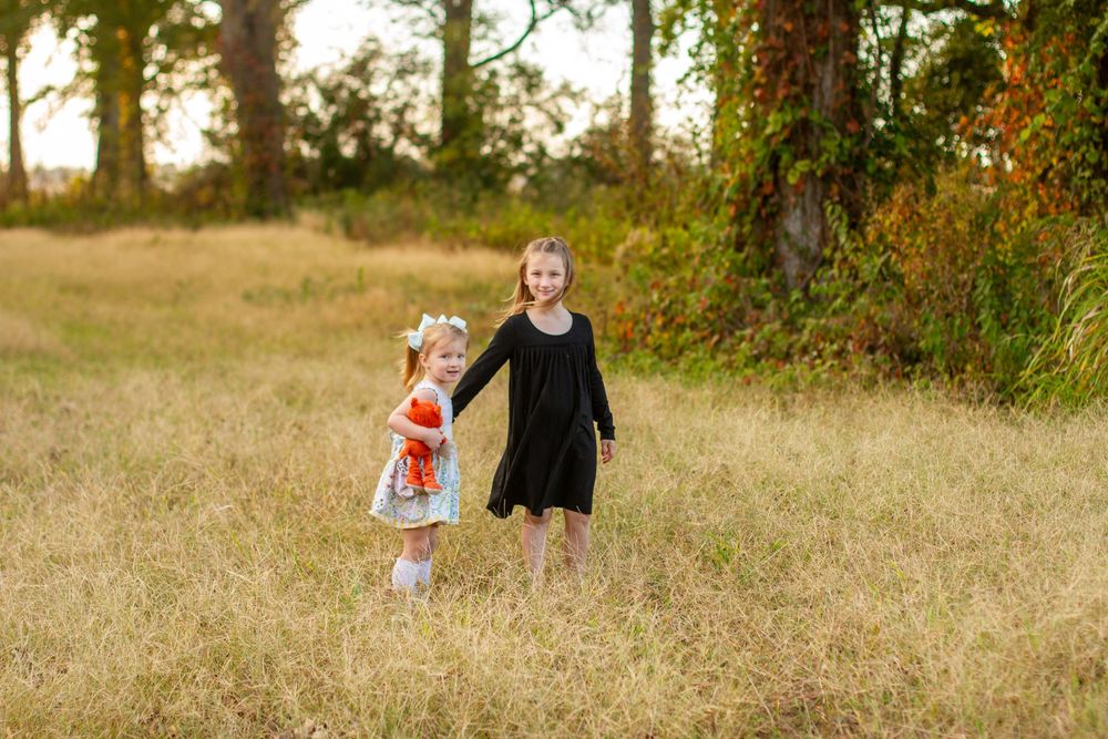 sisters in a field photographed by Delta Blossoms Photography in Manila, Arkansas