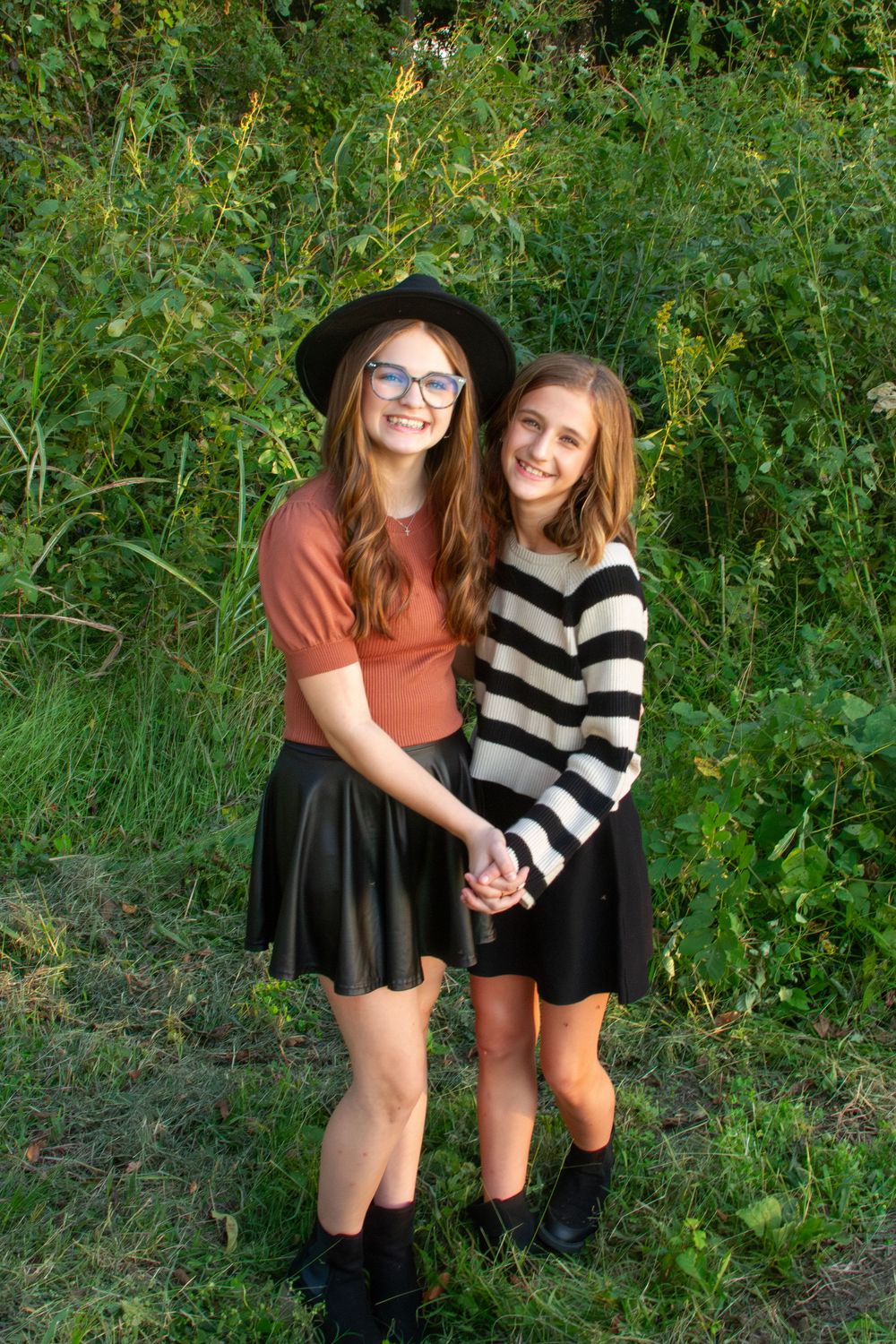 sisters in a field photographed by Delta Blossoms Photography in Manila, Arkansas