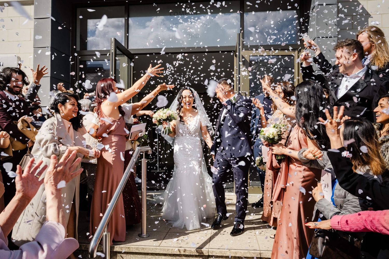 Wedding Photographer Kent confetti shot as bride and groom leave ceremony