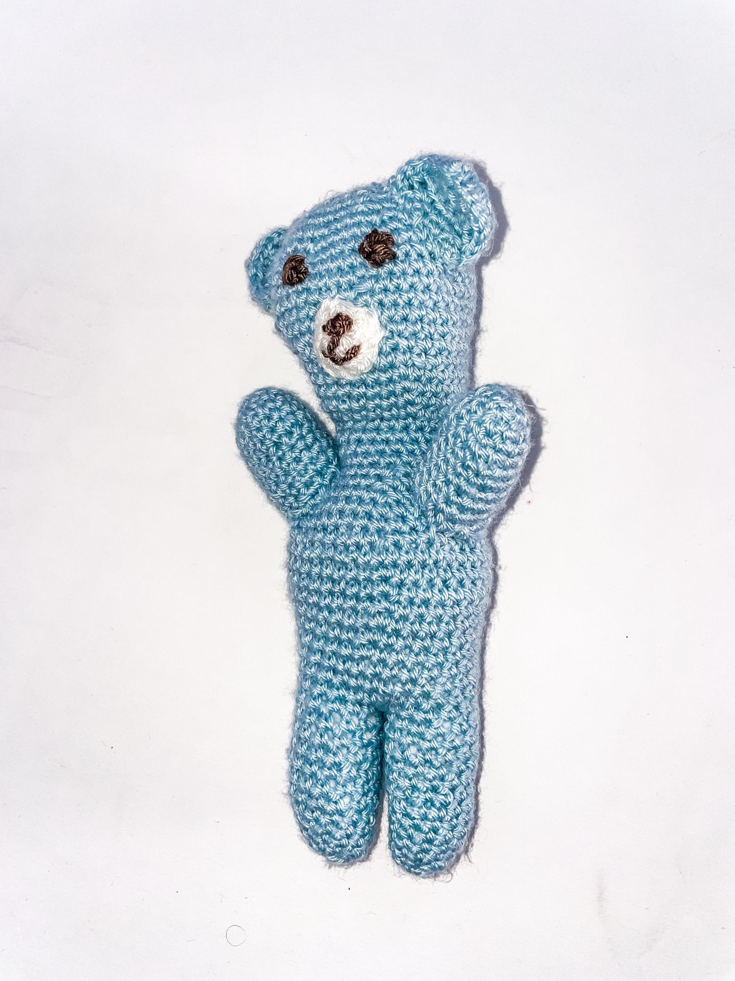 Light blue crochet amigurumi bear toy photographed from multiple angles.