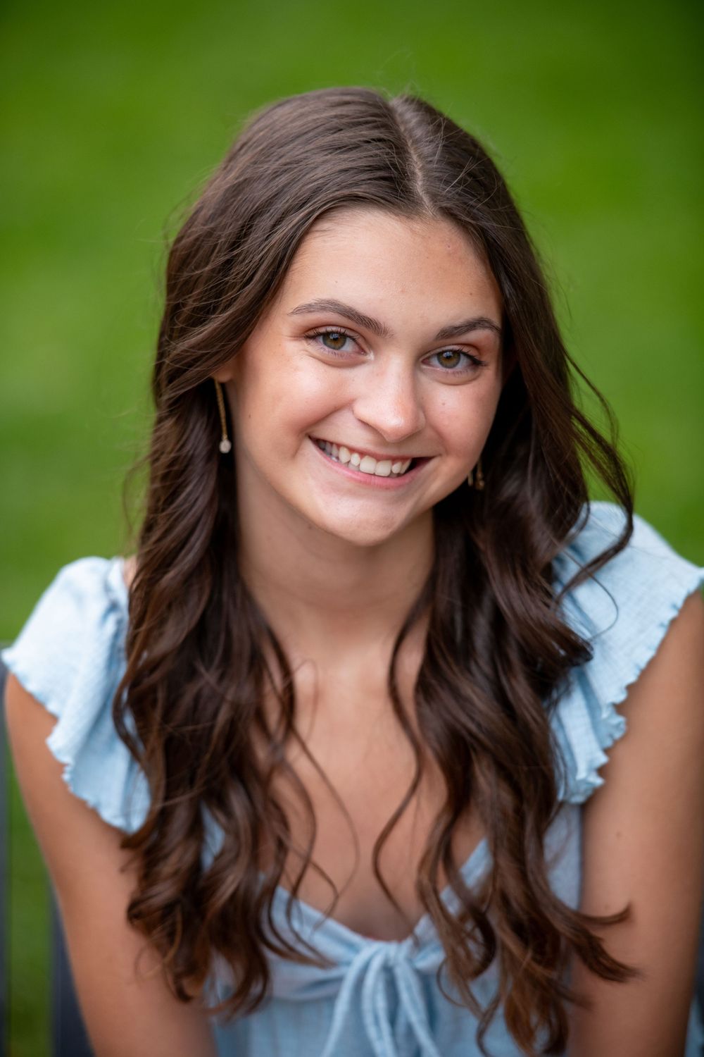 Portrait series against green background showcasing casual summer style and natural expressions.