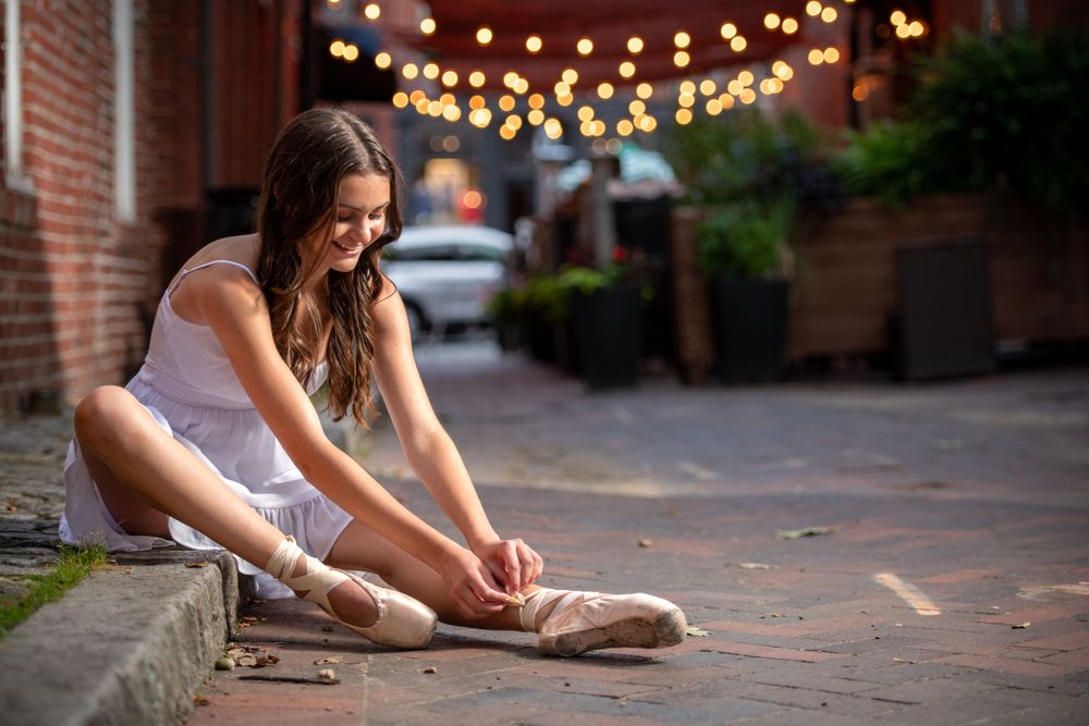 Casual evening photos with string lights creating bokeh effect in urban setting.