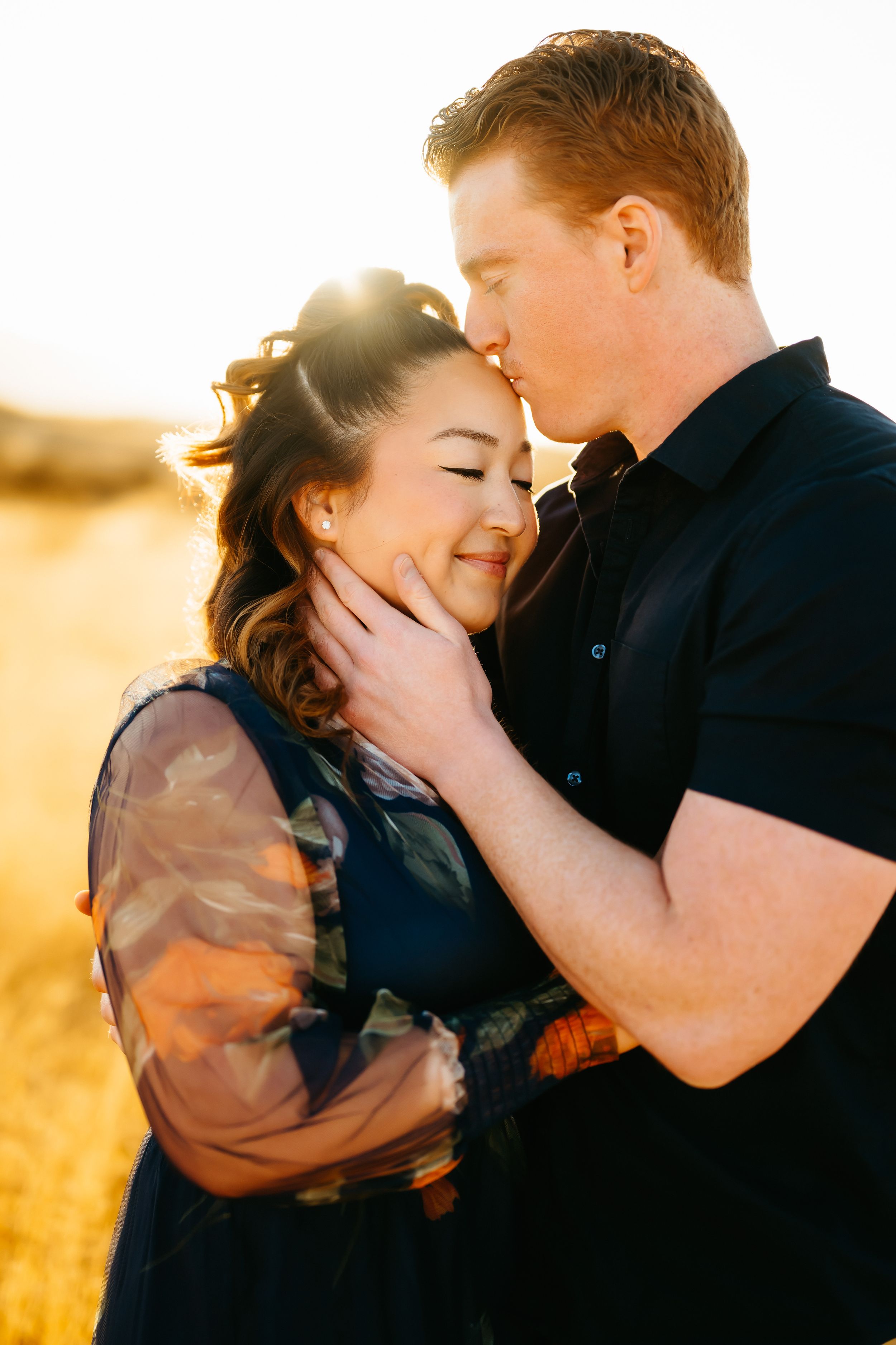 Engaged couple hugging in Tucson desert at golden hour