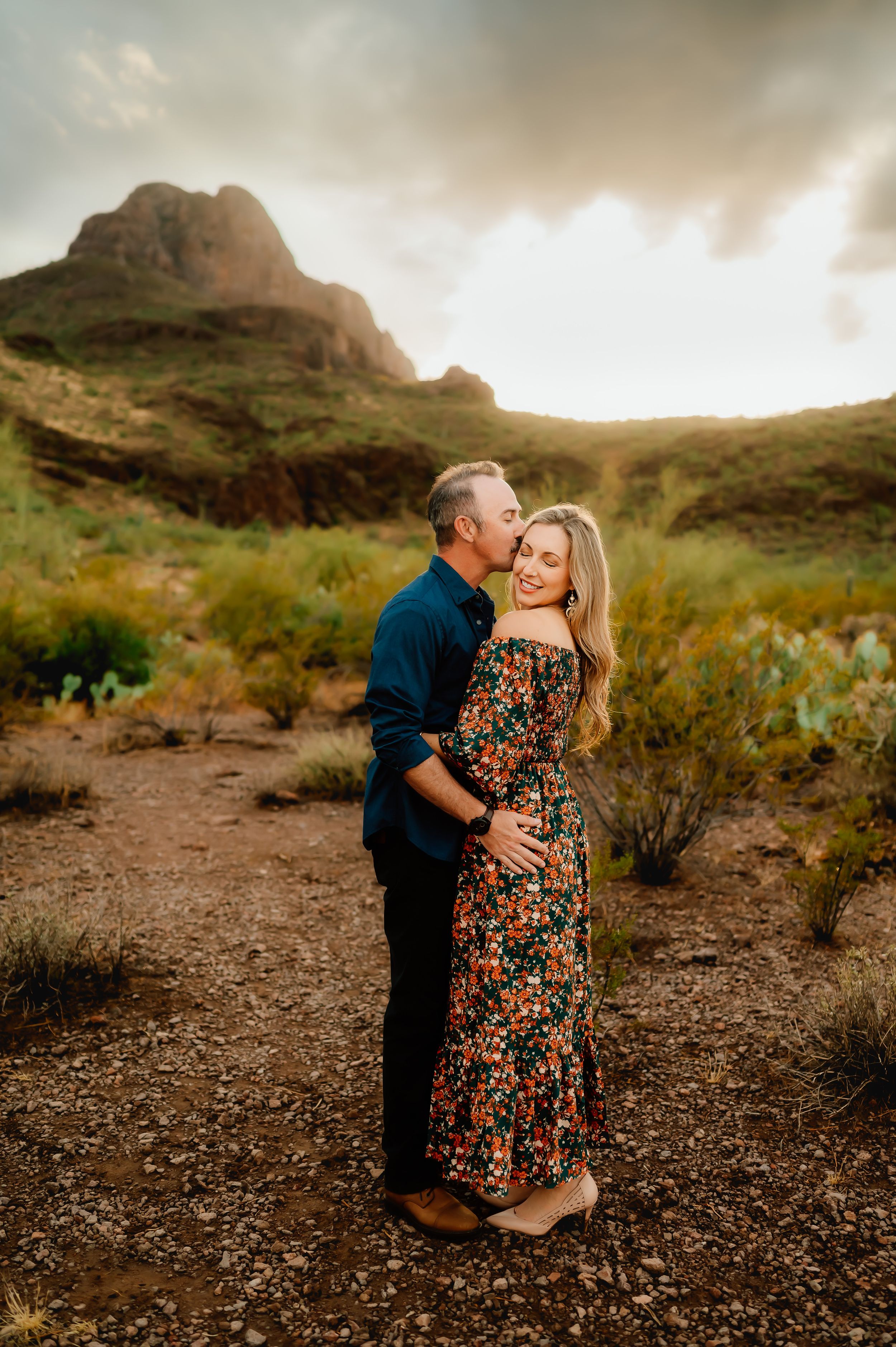 Stunning sunset couple session with mountain backdrop.