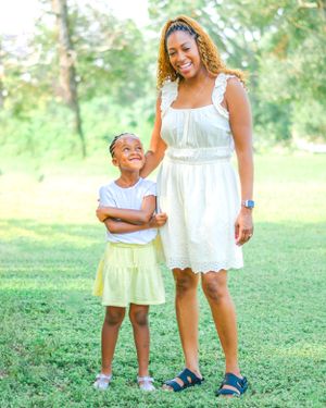 Sweet outdoor photography session in a grassy park on a bright summer day.