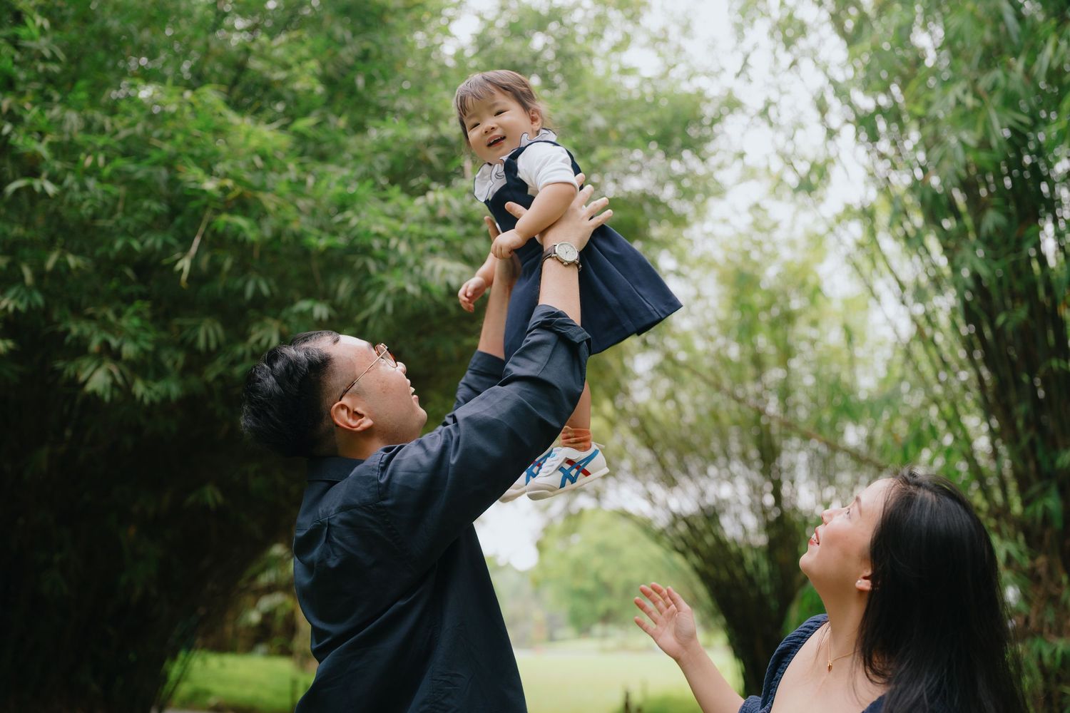 Parent and child play together outdoors while looking up at the sky in a series of joyful moments.