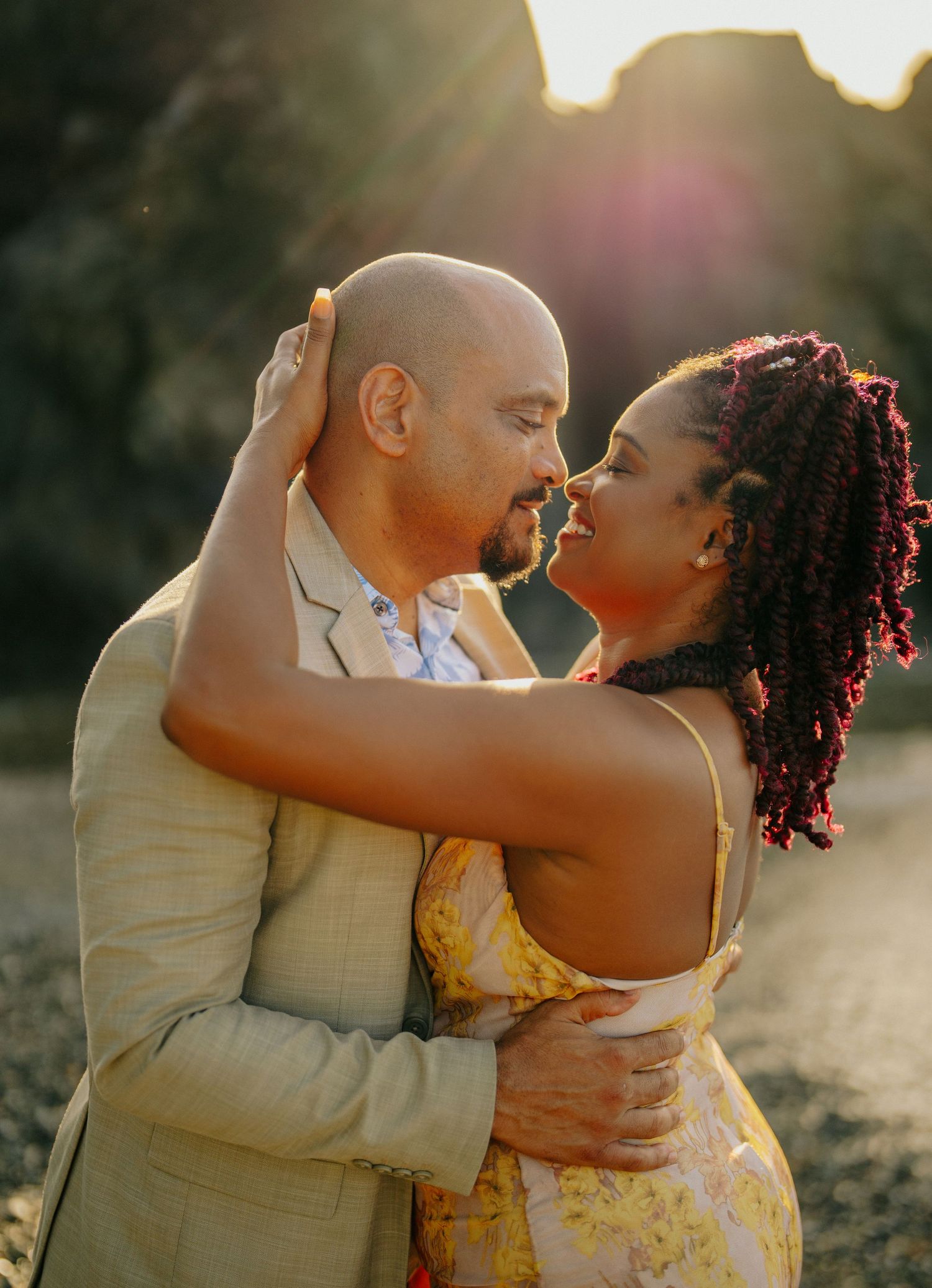 Intimate sunset engagement portrait in warm golden light.