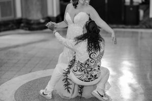 Bride smiling as the groom gets low while dancing their first dance as husband and wife.