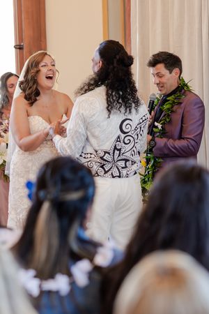 Bride at the alter laughing out loud in a very candid way at the story being told by the officiant.