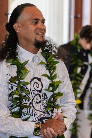 Groom standing at the alter seeing his bride for the first time. He is holding back the tears of happiness.