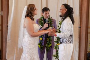 Bride and groom laughing with each other during their wedding ceremony looking each other in the eyes.