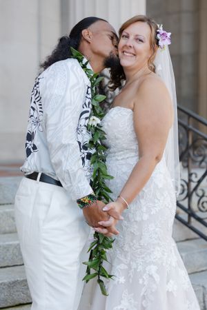 Groom is nuzzling into the brides neck.