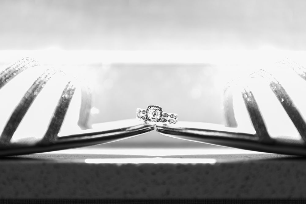 Diamond engagement ring photographed in dramatic black and white perspective.
