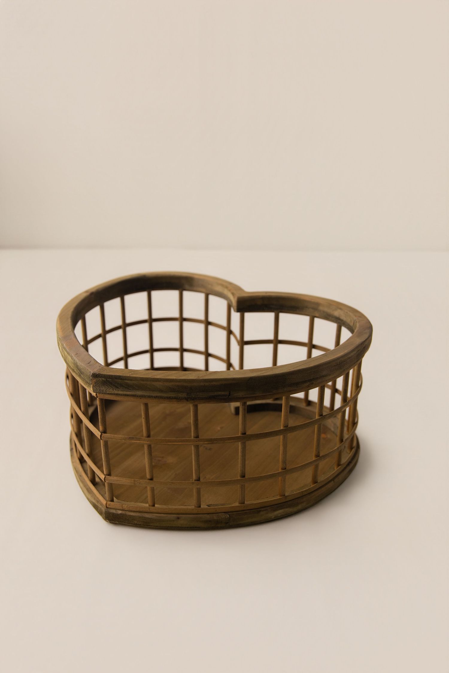 Heart-shaped rustic wire basket with wooden frame, perfect for storage or decor display.