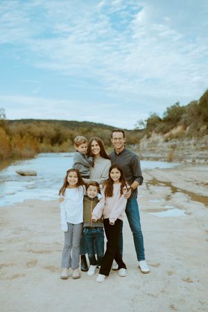 Colorful photo of kids playing by the river in an an outdoor family photo shoot in Central Texas.