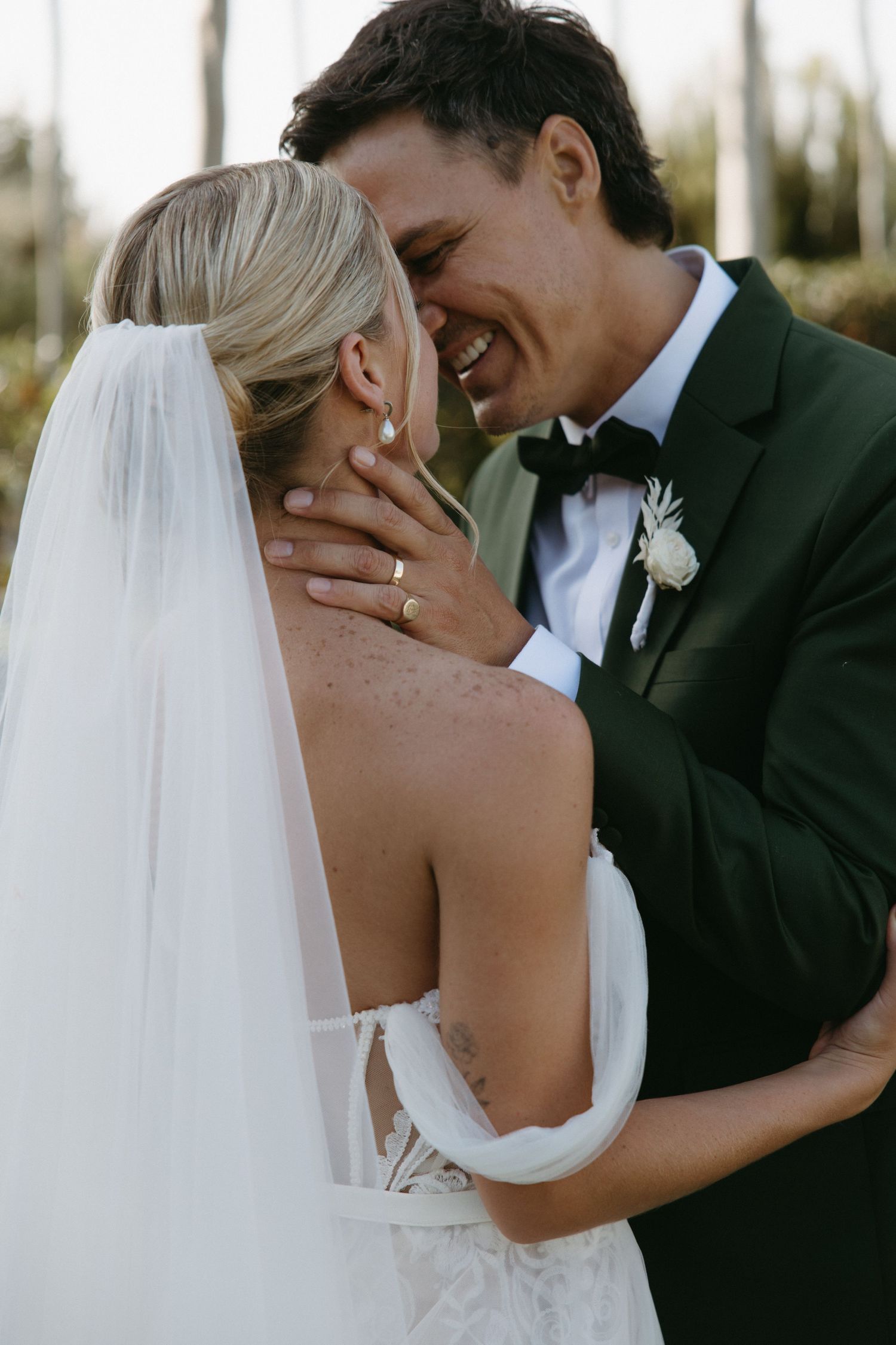 Romantic wedding couple shares tender moments in elegant black and white photography.