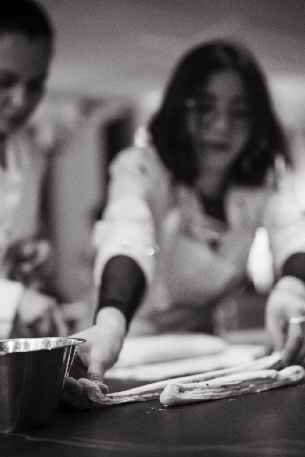 a woman laying out dough for cinnamon buns at Aveqia Stockholm while being captured by event photographer