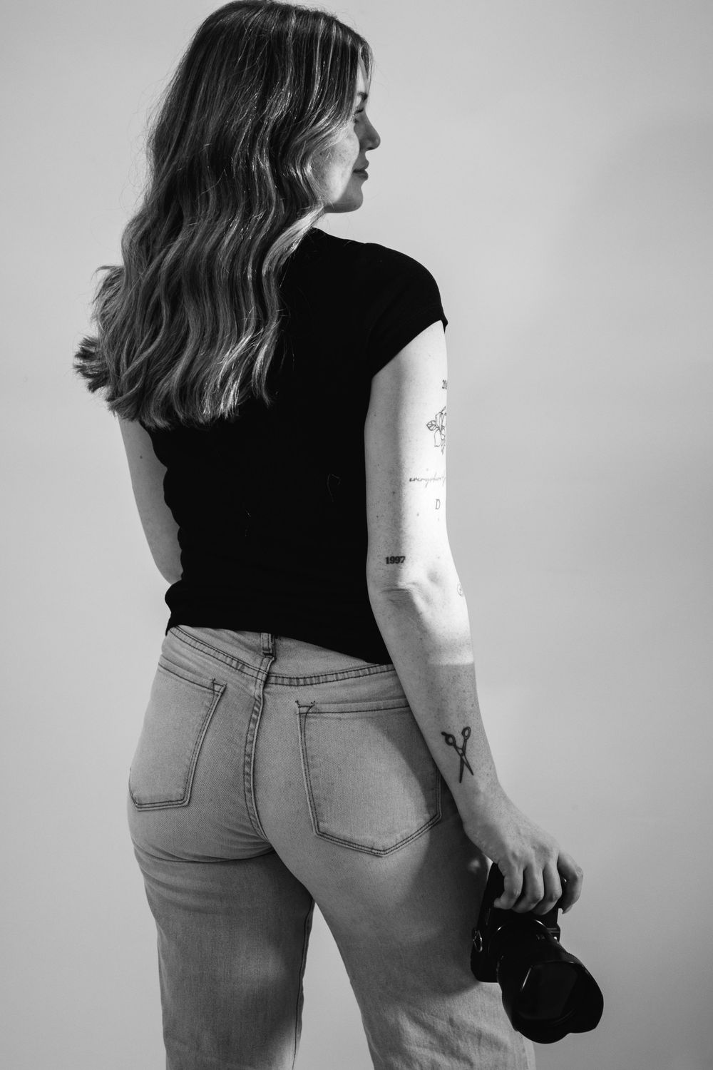 Series of black and white photos showing person in casual attire from different angles.