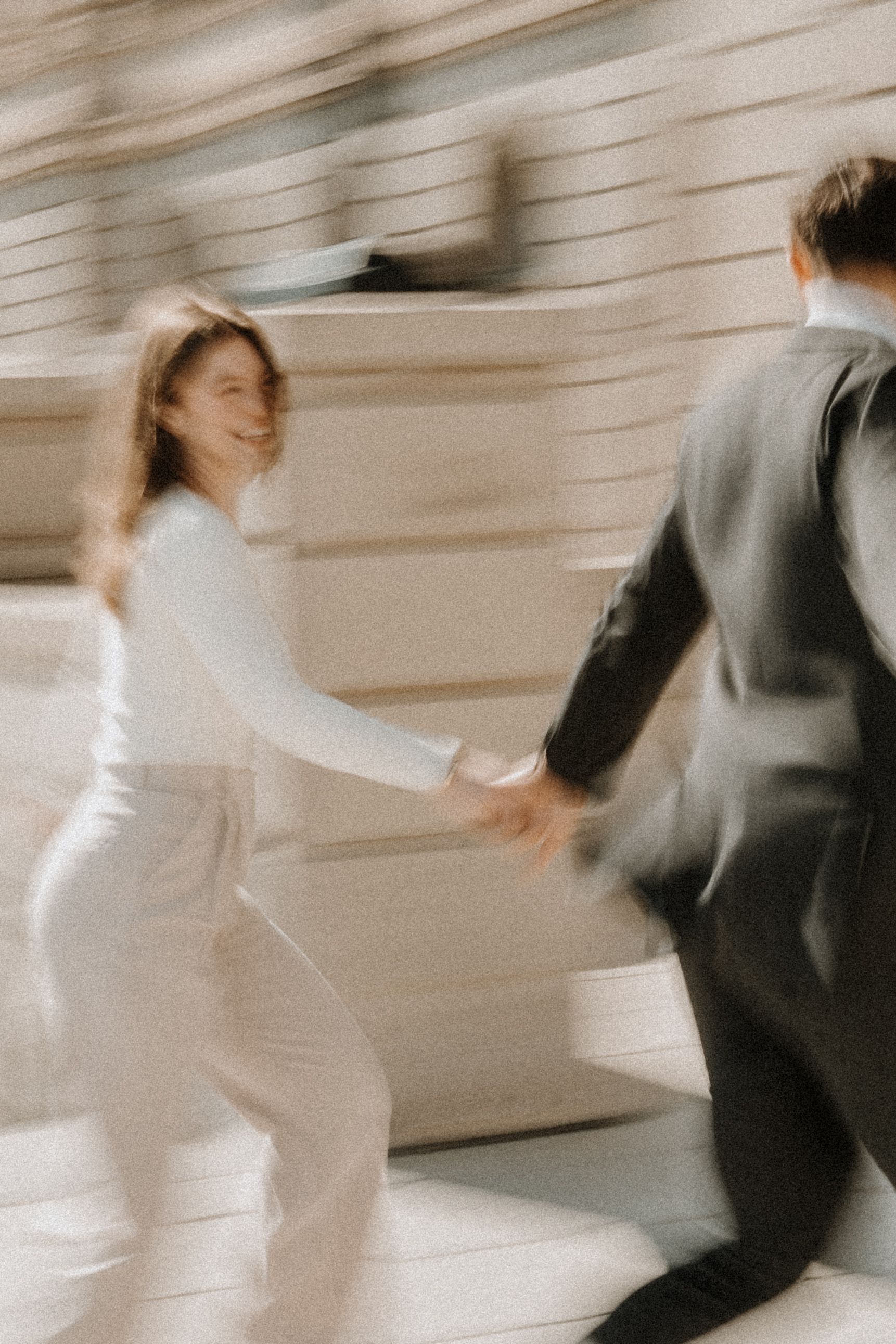 Motion blur sequence showing a couple in wedding attire dancing and spinning.