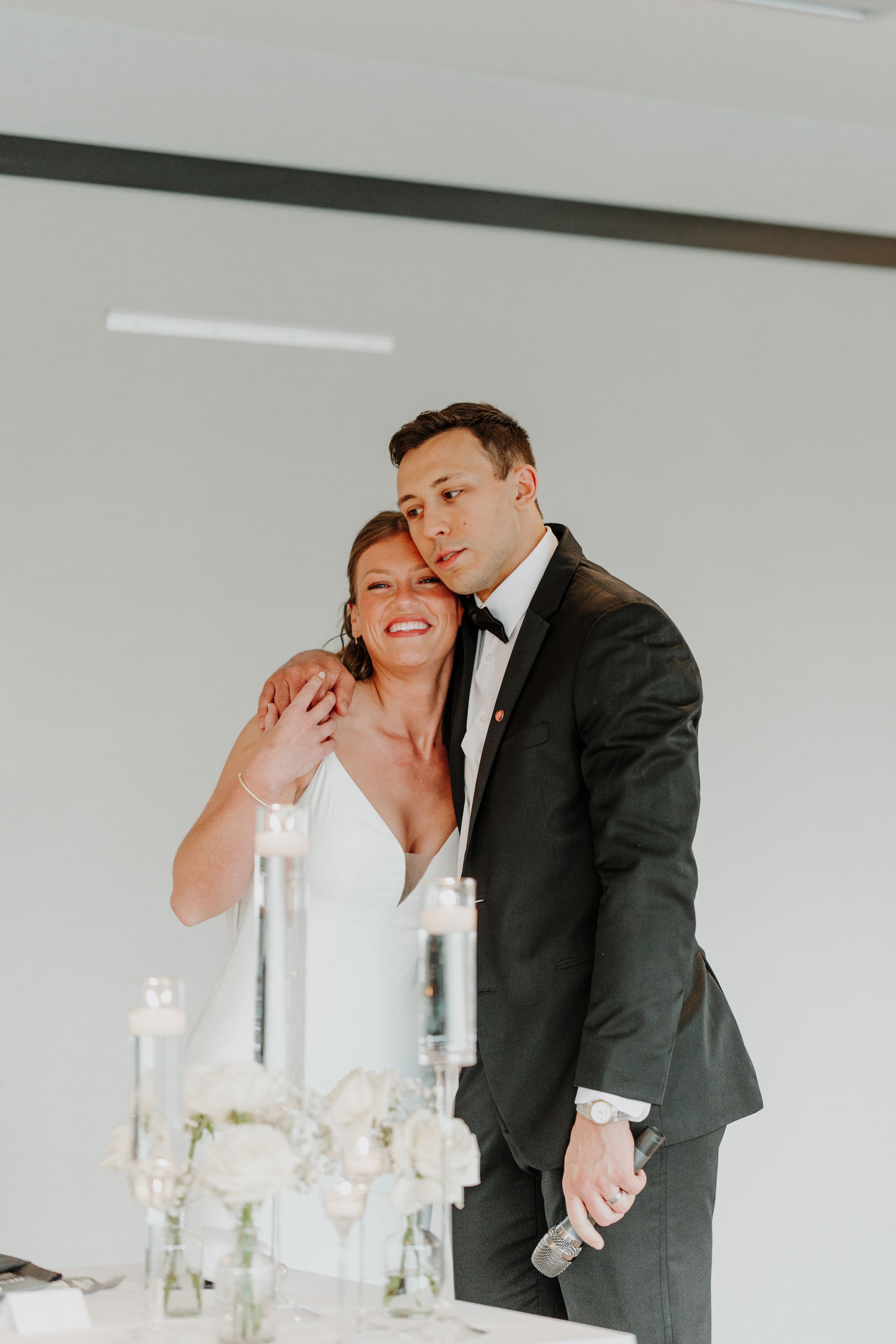 Black and white wedding reception candid moments captured at an elegant venue.
