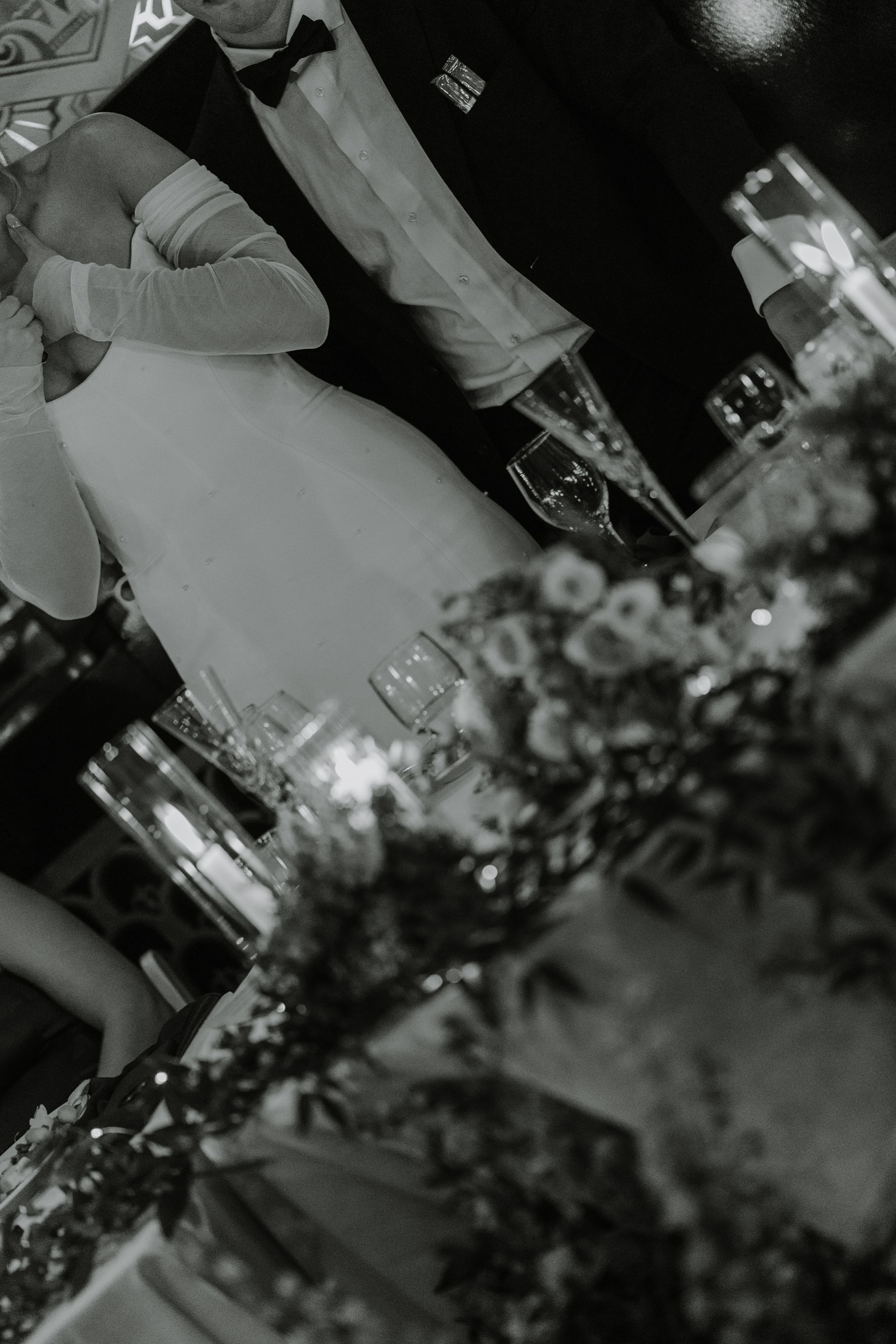 Artistic black and white shot of couple dancing at wedding reception.