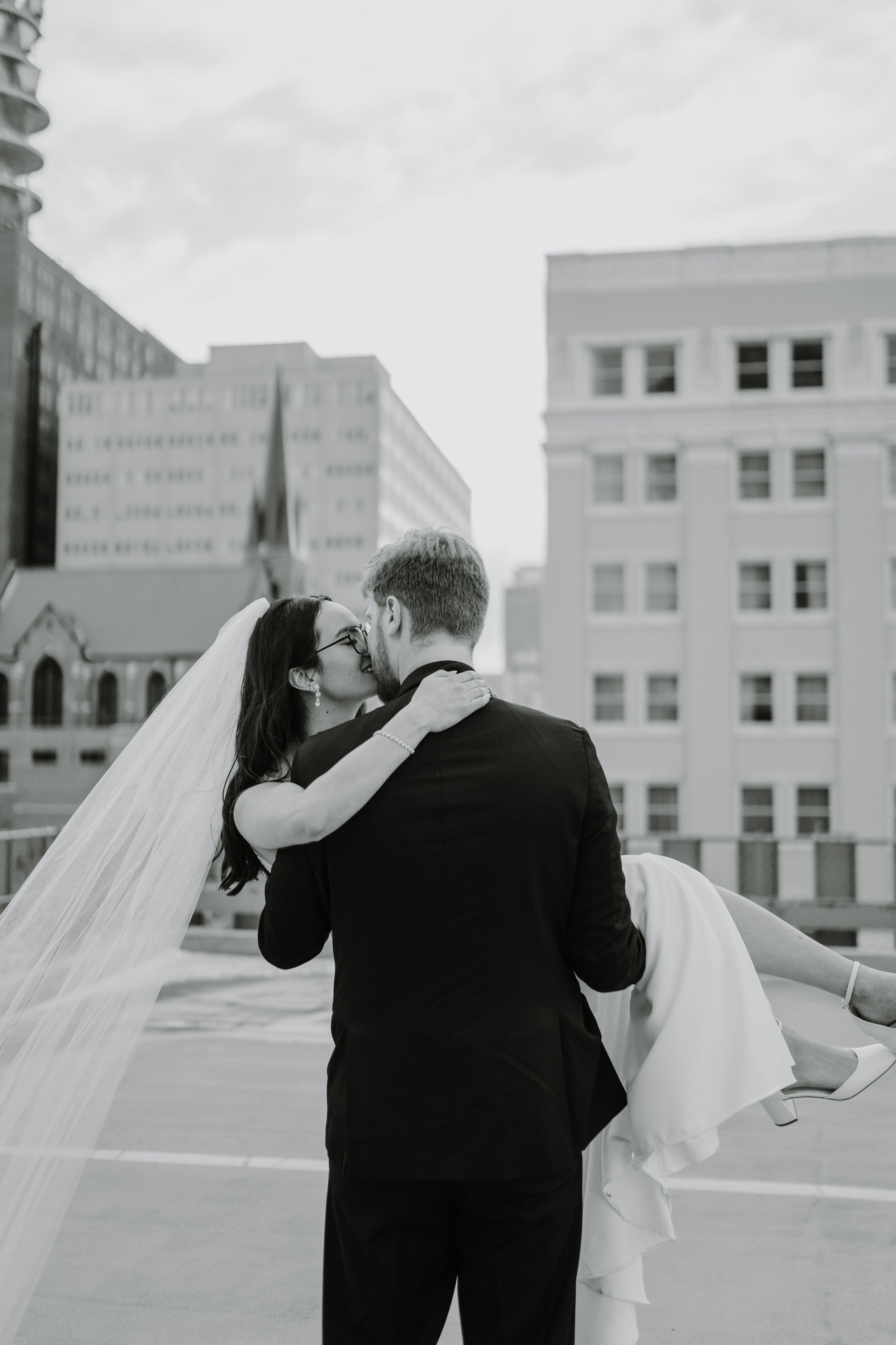 Black and white rooftop wedding photos capturing intimate moments between newlyweds.