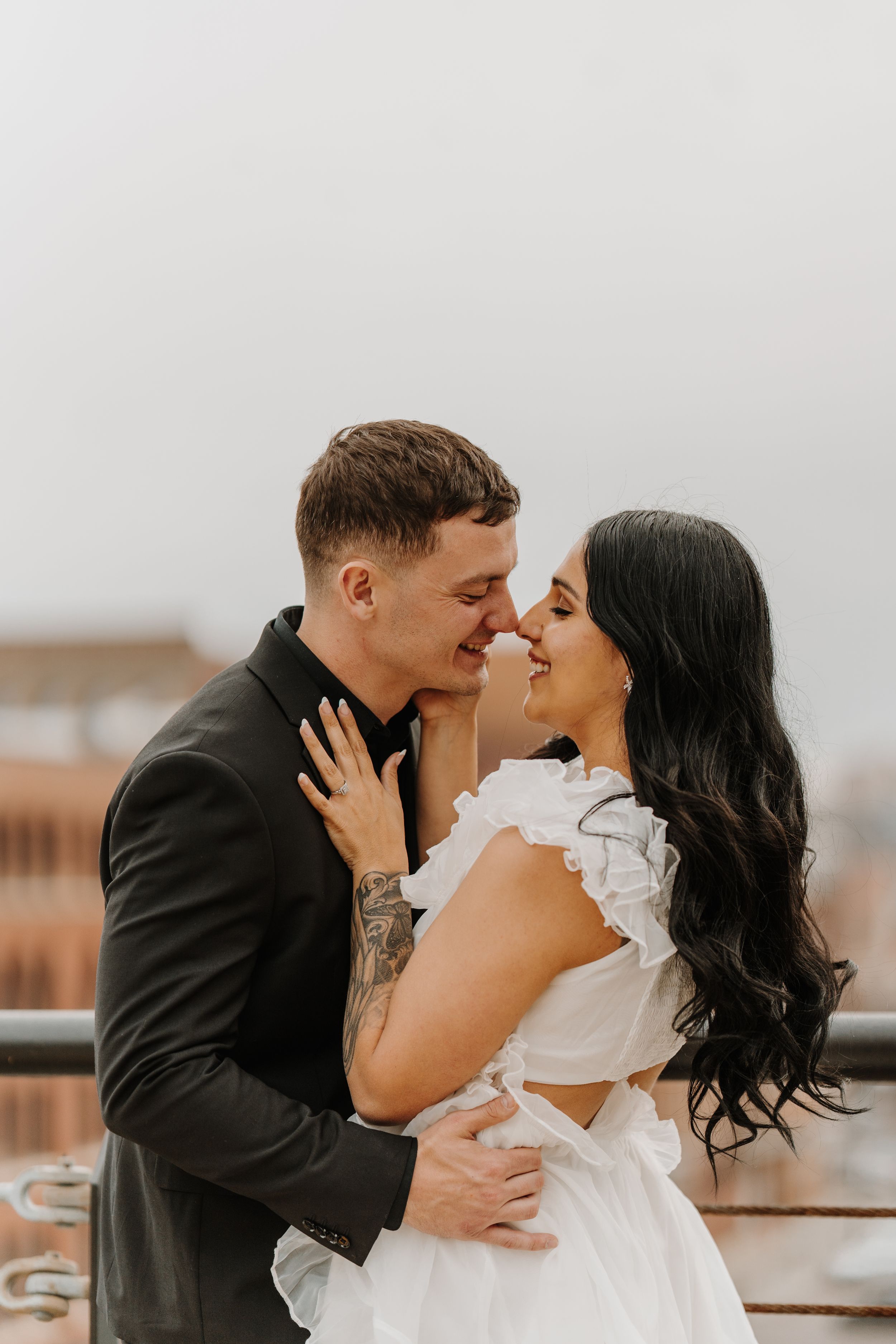 A sequence of romantic rooftop photos showing a couple embracing and kissing.